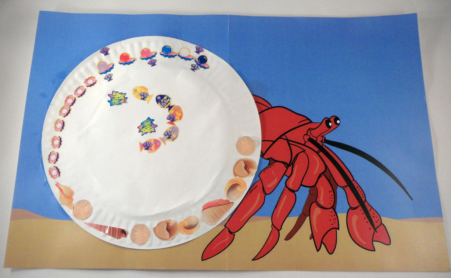 A decorated shell. A House for Hermit Crab - Ivy Kids subscription box activities.